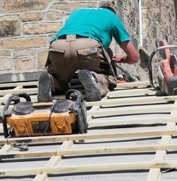 Roofer in Nottingham working on roof